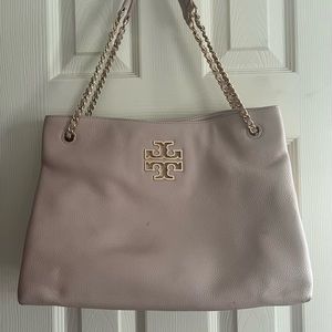 Pale pink Tory Burch adjustable strap purse.